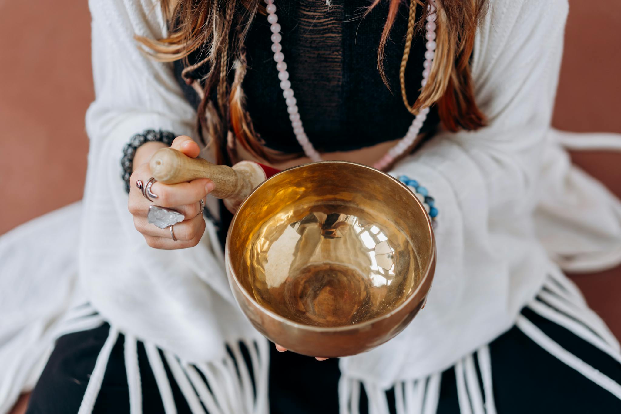A Woman Holding A Singing Bowl Engaging